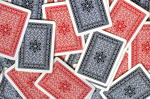 Bild auf Leinwand Texture of red and blue playing cards back spread on a table