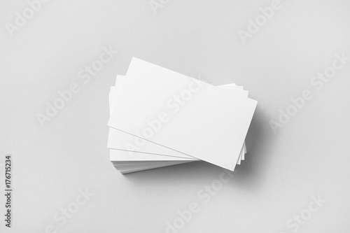 Photo of blank business cards with soft shadows on paper background. Template for ID. Mock up for branding identity. Top view.