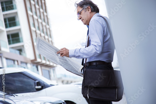 Man reading newspaper at outdoor