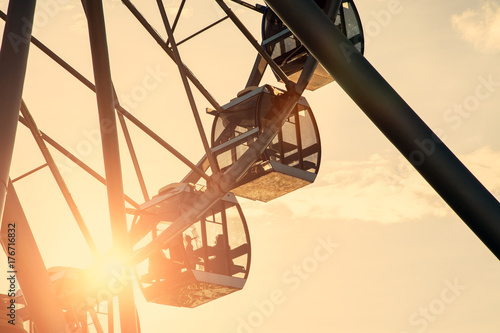 Ferris wheel on sunset sky background