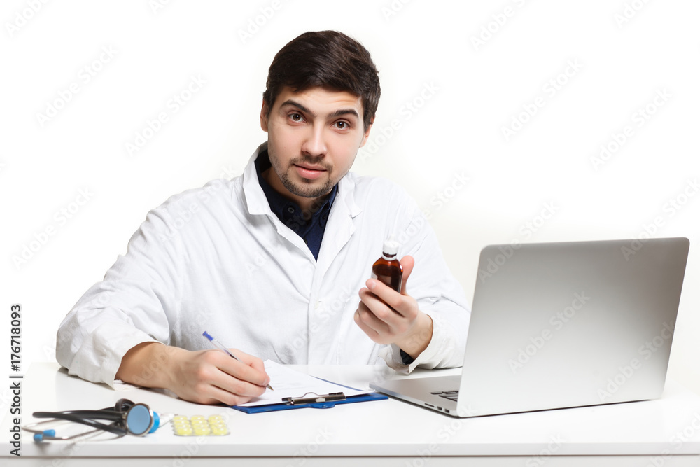 handsome doctor man in his office at the desk, looking at the lens handsome doctor man in his office at the desk, looking at the lens