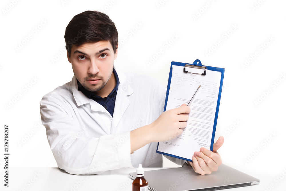 handsome doctor man in his office at the desk, looking at the lens handsome doctor man in his office at the desk, looking at the lens