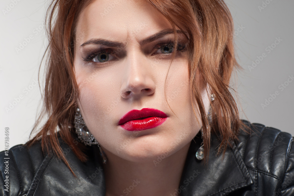 Suspicious look. Aggressive confident lady. Relationships problems, distrust in partner. Angry stylish female portrait on grey background closeup, suspicion concept Suspicious look. Aggressive confident lady. Relationships problems, distrust in partner. Angry stylish female portrait on grey background closeup, suspicion concept