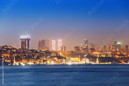 night view of illuminated towers and skyscappers in istanbul  taken from seaside