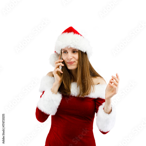 Beautiful woman in Santa Claus clothes using smartphone on white background
