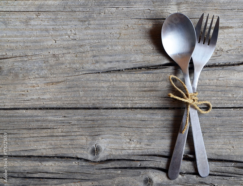 Cutlery set:fork and spoon on rustic wooden table.Cutlery on old wooden background.Can be used as background menu for restaurant.Top view.Copy space.Selective focus.