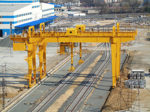 Yellow crane at an industrial plant.      