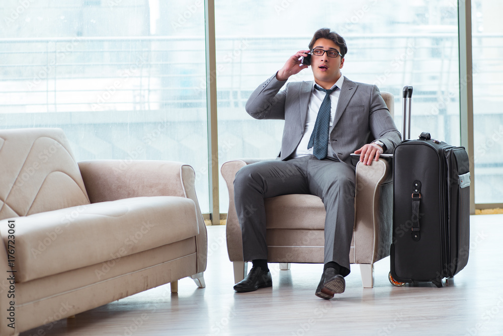 Young businessman in airport business lounge waiting for flight Young businessman in airport business lounge waiting for flight