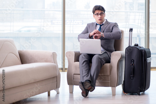 Young businessman in airport business lounge waiting for flight