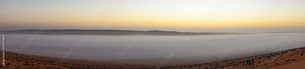 Panoramic of Sunrise in Wahiba Sands desert in Oman with mist