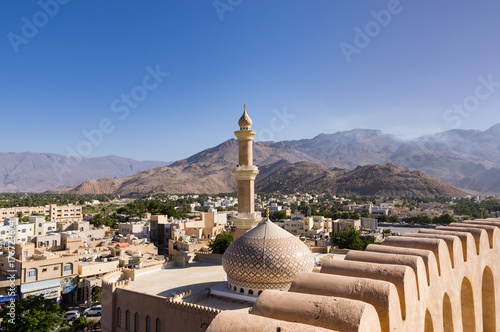 The Grand mosque and minaret in Nizwa viewed from the Nizwa fortress in Oman.