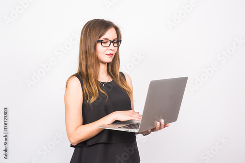 business, technology and people concept - businesswoman with laptop on white background