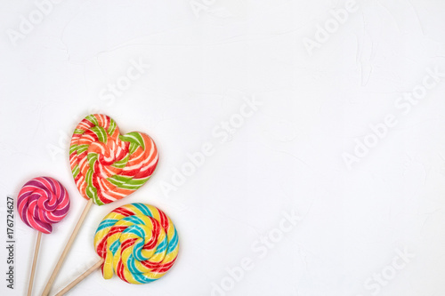 Swirl rainbow lollipop candy on white background