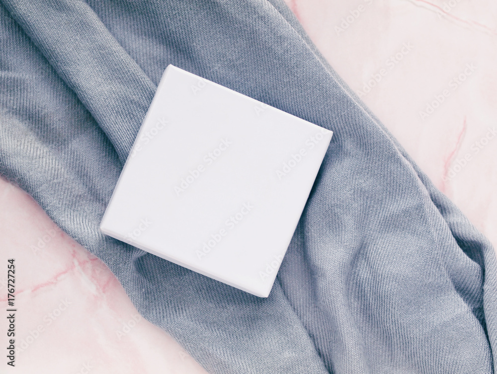 White square package or box for jewelry or presents on pink marble desk or table background. Flat lay. Top view. Copy space. White square package or box for jewelry or presents on pink marble desk or table background. Flat lay. Top view. Copy space.
