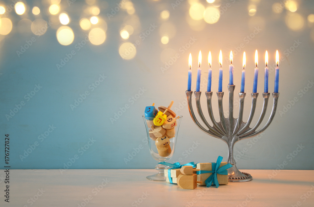image of jewish holiday Hanukkah background with traditional spinnig top, menorah (traditional candelabra) image of jewish holiday Hanukkah background with traditional spinnig top, menorah (traditional candelabra)