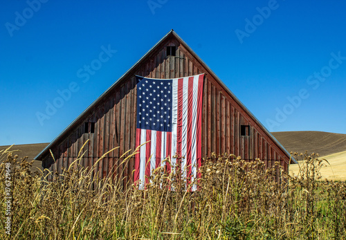 Weathered Red Barn with American Flag