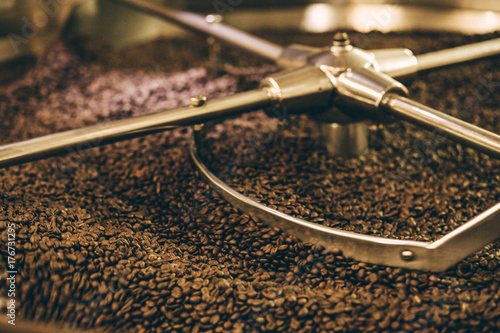 coffee beans in roast machine, arabica roasted coffee - vintage tone