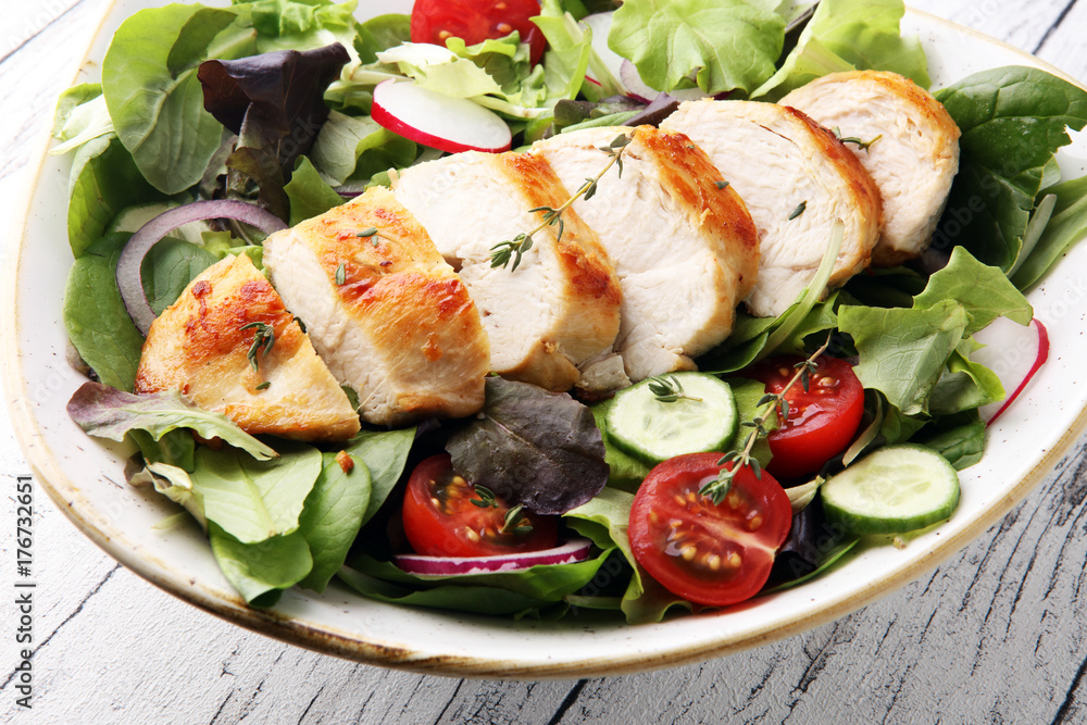 Chicken salad with leaf vegetables and cherry tomatoes. Chicken salad with leaf vegetables and cherry tomatoes.