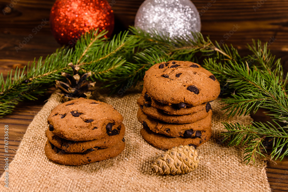 Chocolate chip cookies and christmas decorations on a wooden table Chocolate chip cookies and christmas decorations on a wooden table