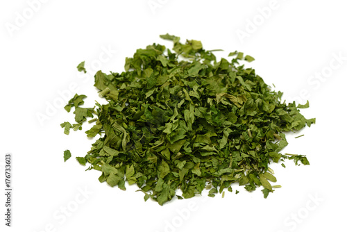 pile of green dried parsley on a white background