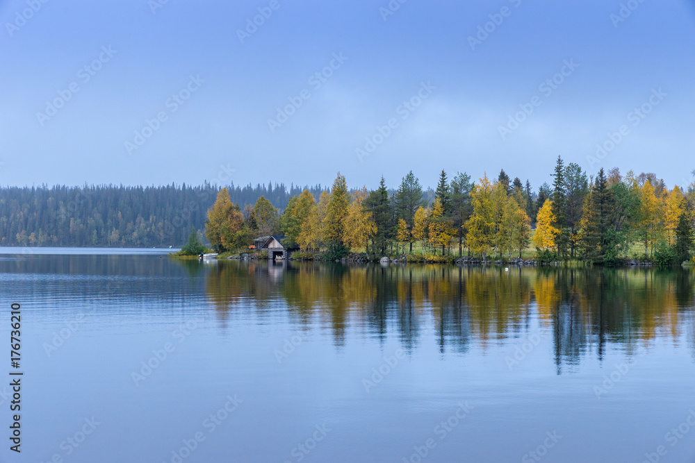 Forests and lake view in autumn. Fall colors - ruska time in Ruka. Finland, Lapland, Nordic countries in Europe