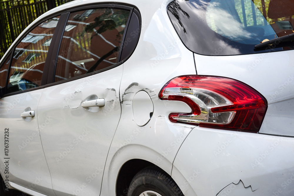 A car with a scratch on the body. Close-up