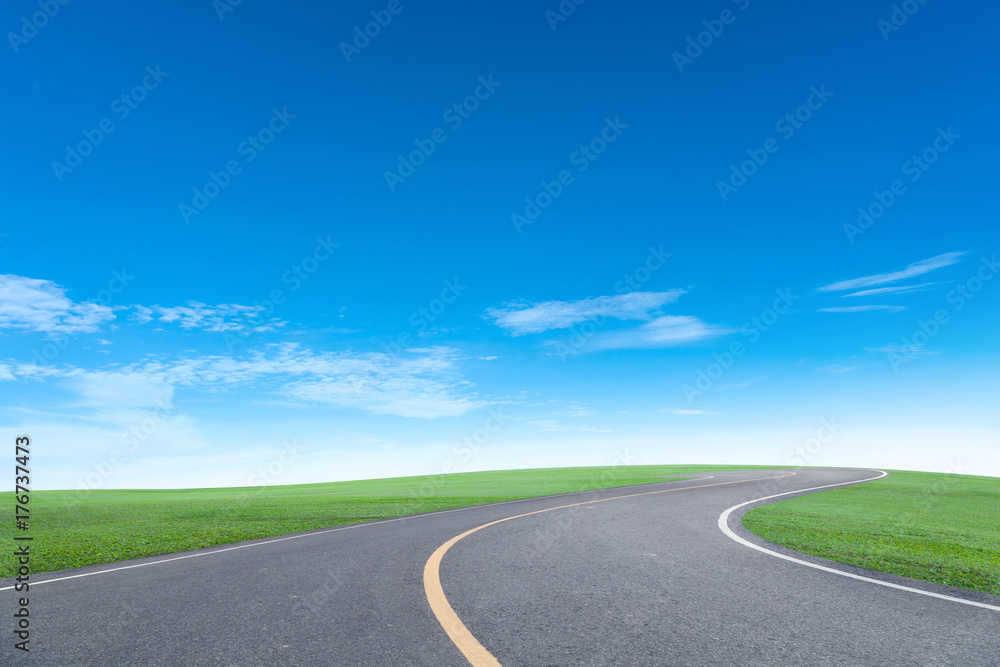 Asphalt road with green grass field scenery blue sky white cloud background. Asphalt road with green grass field scenery blue sky white cloud background.
