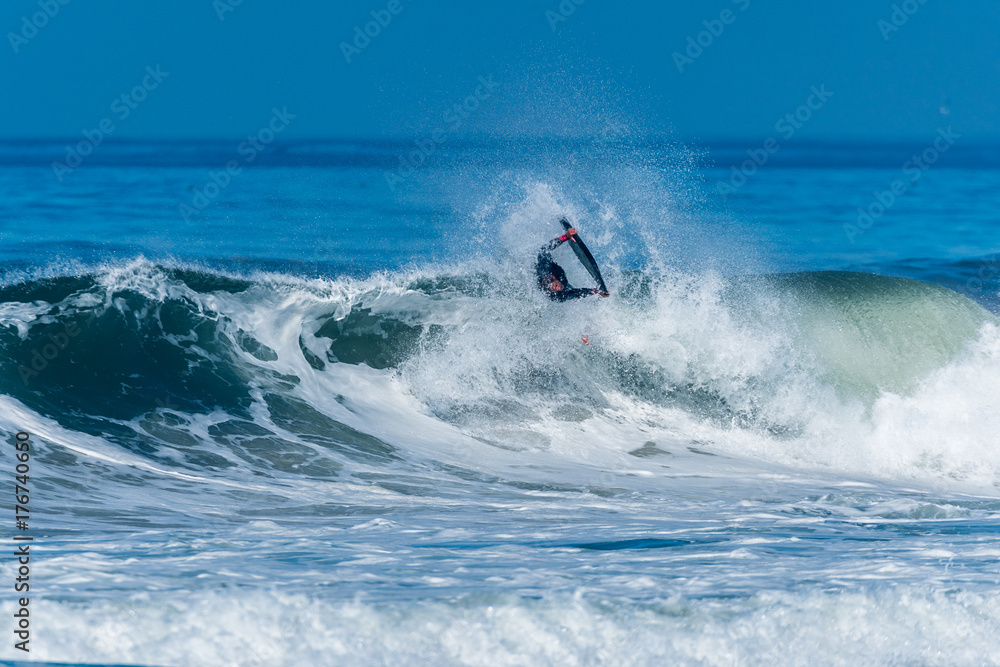 Bodyboarder surfing ocean wave