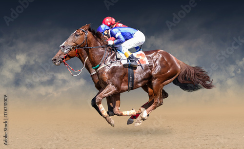 Fotografia Two racing horses neck to neck in fierce competition for the finish line