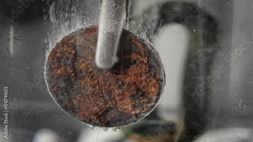 Cleaning rusted coin with electrolysis zoom in