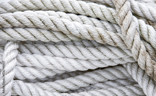 close up of tangled and twisted grungy white nautical rope