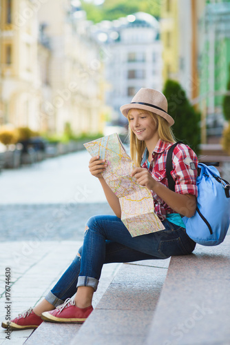 teenage girl looking at map. Tourism and Vacation concept © dreamsnavigator