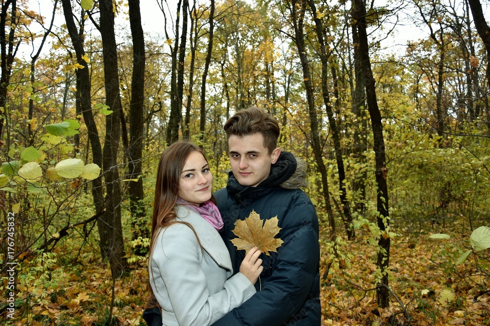 young loving couple in the autumn forest young loving couple in the autumn forest