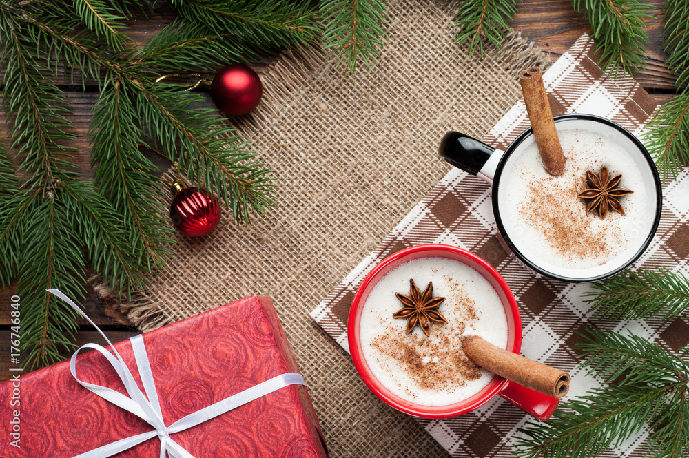 eggnog cocktail in mug arranged with christmas decoration on wooden table eggnog cocktail in mug arranged with christmas decoration on wooden table