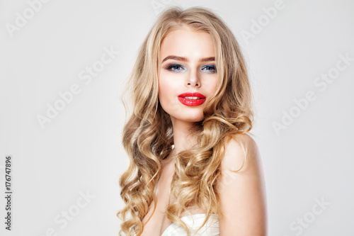 Nice Young Woman with Makeup and Blonde Wavy Hair. Portrait of Cute Girl