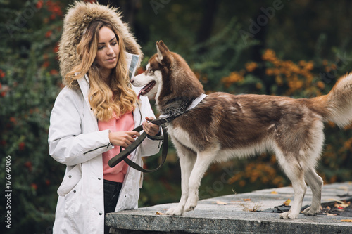 Woman with her dog in park at autumn