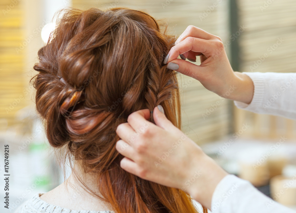 Beautiful, red-haired girl with long hair, hairdresser weaves a French braid, in a beauty salon. Professional hair care and creating hairstyles. Beautiful, red-haired girl with long hair, hairdresser weaves a French braid, in a beauty salon. Professional hair care and creating hairstyles.