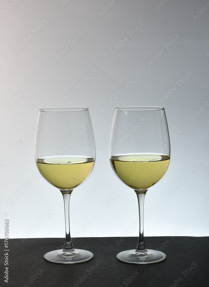An isolated couple glasses of white wine with white background An isolated couple glasses of white wine with white background