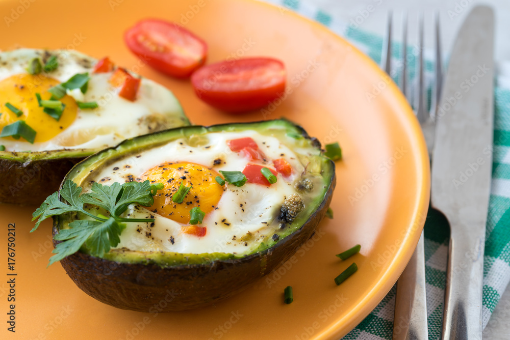 Eggs baked in avocado with bacon, red paprika and chive. Eggs baked in avocado with bacon, red paprika and chive.