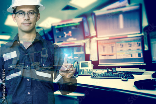 Double exposure of Engineer or Technician man in working shirt press his finger for new innovation with group of computers room background, business and industry concept