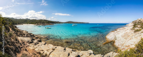 Boats in a small rocky cove with sandy beach in Corsica