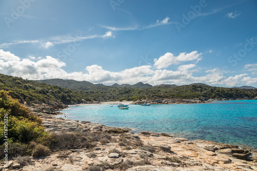 Boats in a small cove with sandy beach in Corsica
