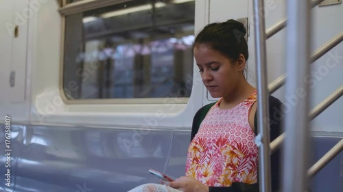 Woman using her Smartphone on New York Subway Train