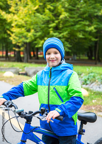 Kid boy outdoor with bike.