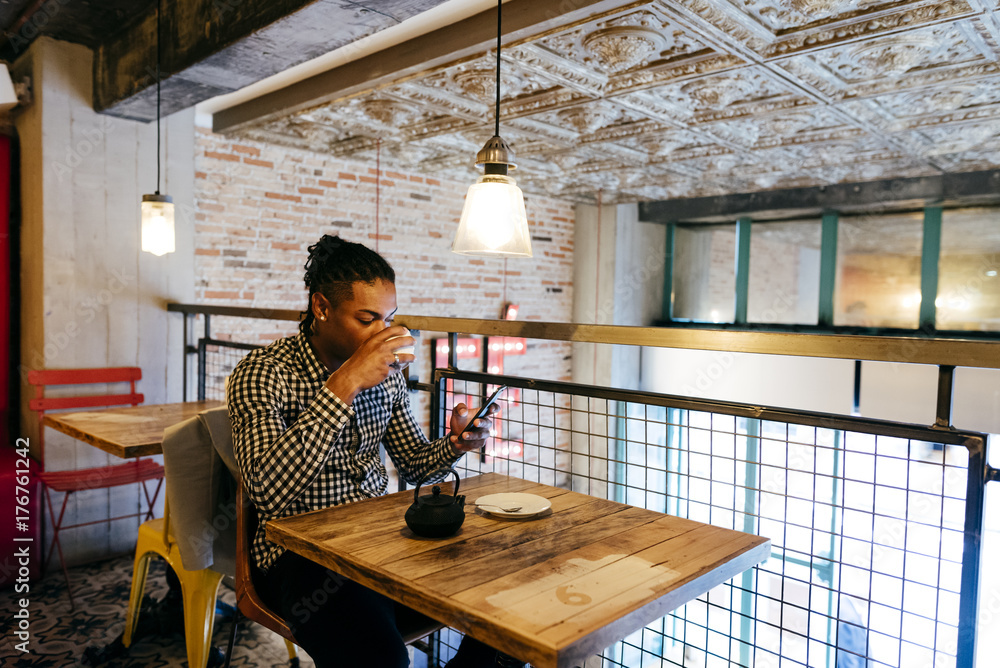 Man drinking tea and using phone Man drinking tea and using phone