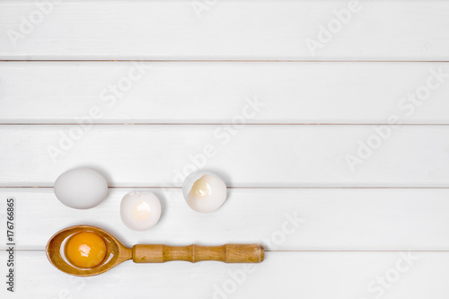 Eggs wooden spoon yolk