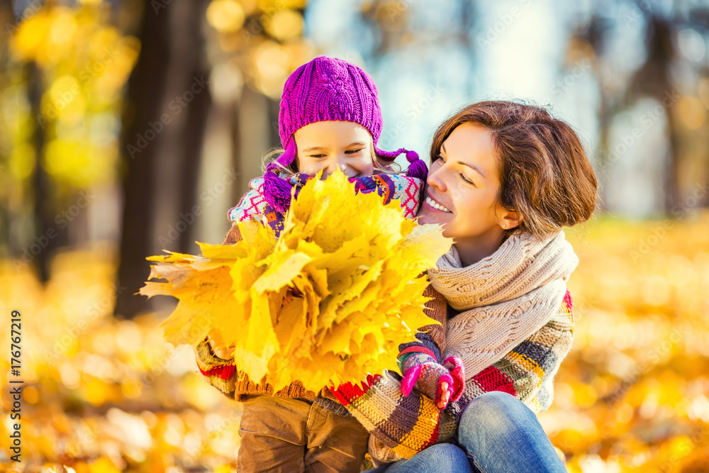 Little girl playing with mother in the autumn park Little girl playing with mother in the autumn park