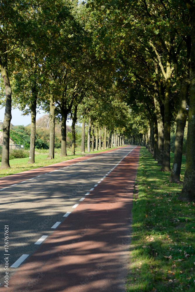Dutch road between villages with bicycle paths, transportation in Europe