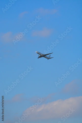 Big white airplane is the air, blue sky, cargo transportation or business travel