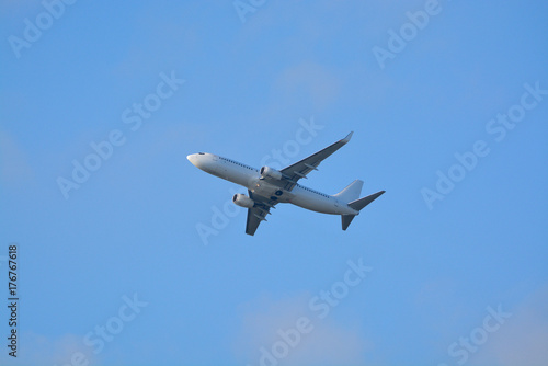 Big white airplane is the air, blue sky, cargo transportation or business travel, copy space